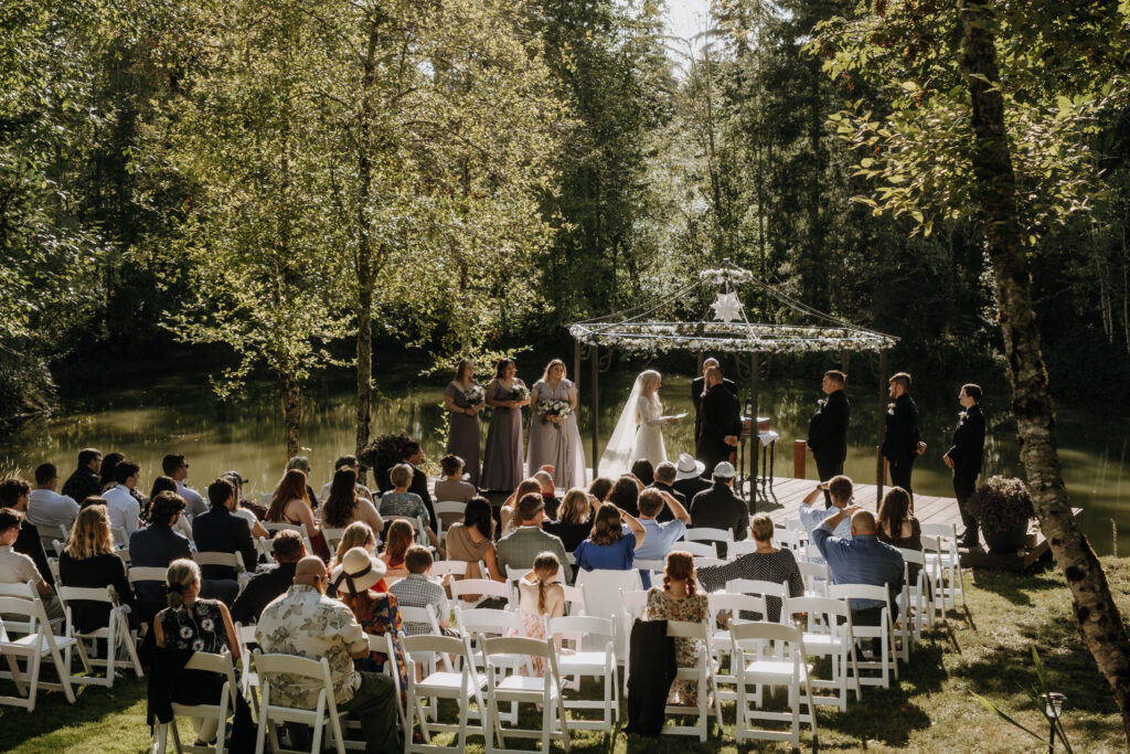 Couple sharing a kiss beneath lavender and greenery at Villa Ragalie, romantic cinematic wedding photography in Oregon.