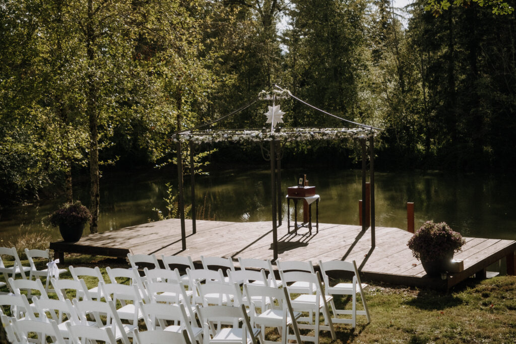 Couple sharing a kiss beneath lavender and greenery at Villa Ragalie, romantic cinematic wedding photography in Oregon.