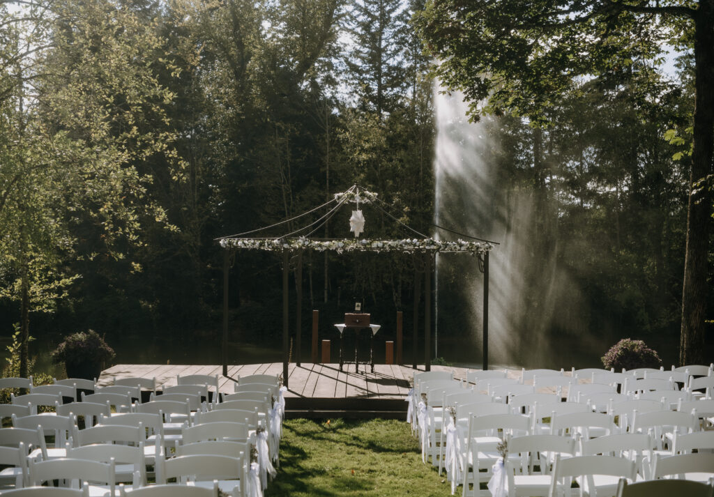 Couple sharing a kiss beneath lavender and greenery at Villa Ragalie, romantic cinematic wedding photography in Oregon.