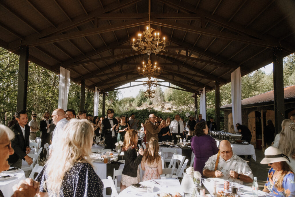 Couple sharing a kiss beneath lavender and greenery at Villa Ragalie, romantic cinematic wedding photography in Oregon.