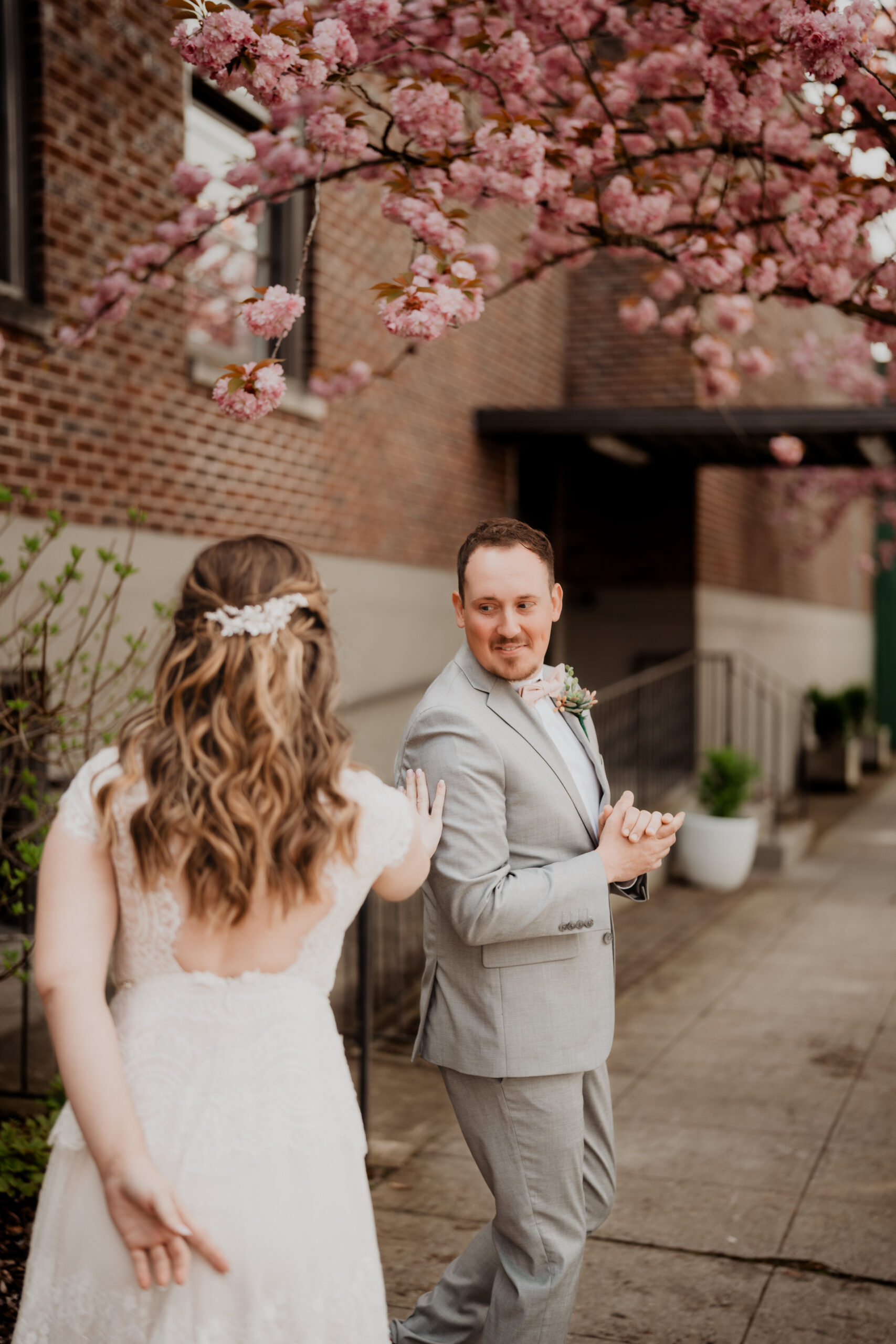 cherry blossom spring wedding couples first look