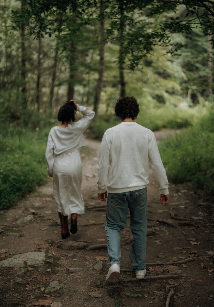 Destination engagement photos at Trash Can Falls in the Blue Ridge Mountains, with overcast skies, lush forest, and romantic waterfall backdrops. Captured by destination wedding and engagement photographer KNCAPTURES