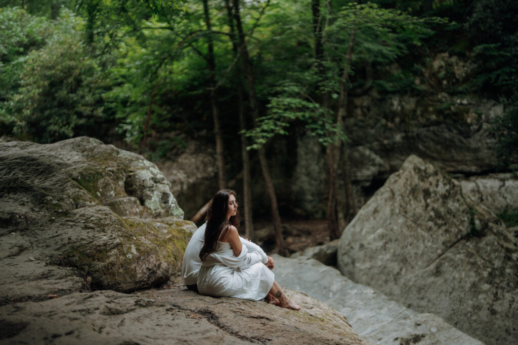 Destination engagement photos at Trash Can Falls in the Blue Ridge Mountains, with overcast skies, lush forest, and romantic waterfall backdrops. Captured by destination wedding and engagement photographer KNCAPTURES