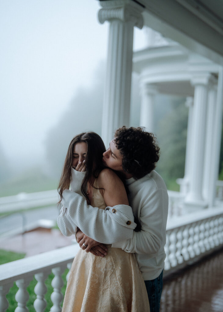 Moody North Carolina engagement photos captured at the couple’s proposal spot in the Smoky Mountains, surrounded by fog and soft overcast light. Romantic and cinematic portraits by destination wedding and engagement photographer KNCAPTURES. Moses Cone