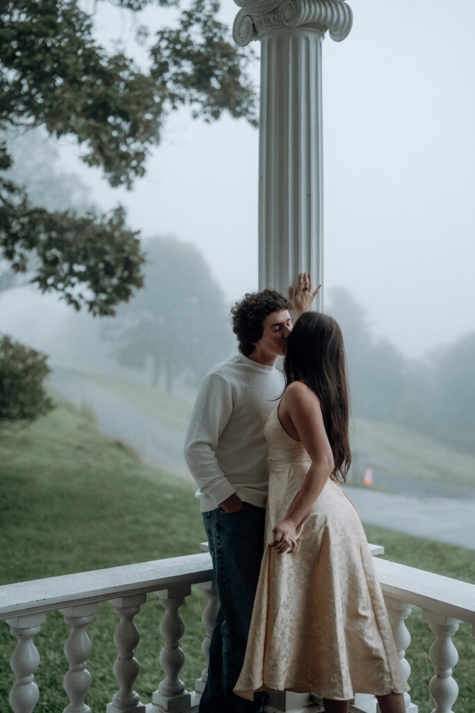 Moody North Carolina engagement photos captured at the couple’s proposal spot in the Smoky Mountains, surrounded by fog and soft overcast light. Romantic and cinematic portraits by destination wedding and engagement photographer KNCAPTURES. Moses Cone