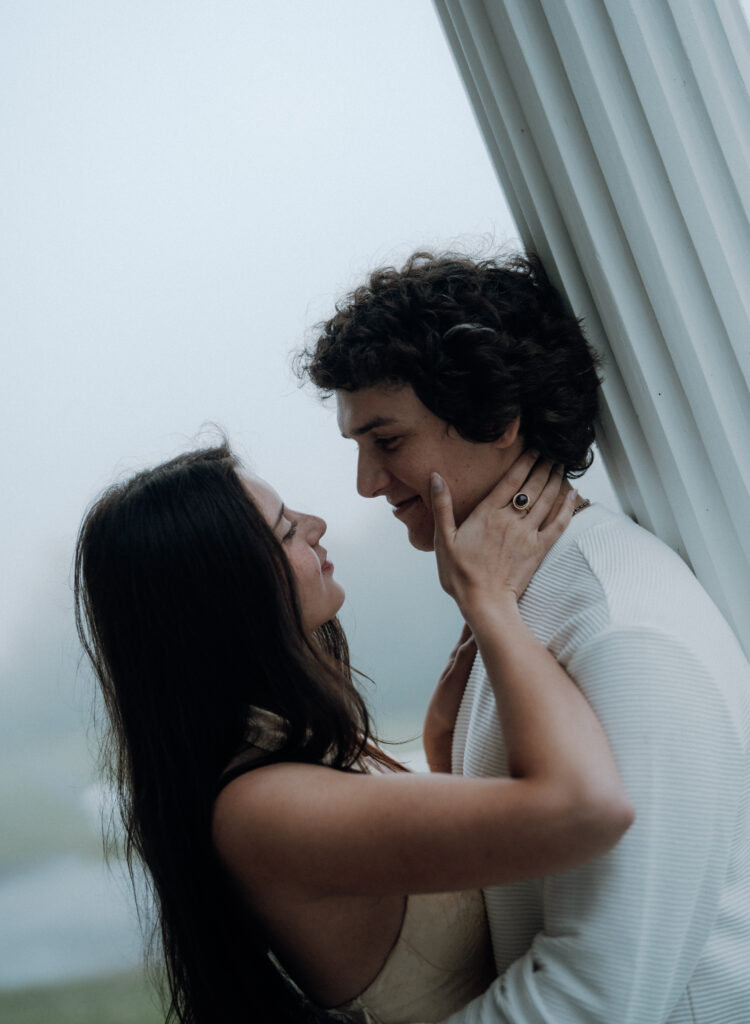 Moody North Carolina engagement photos captured at the couple’s proposal spot in the Smoky Mountains, surrounded by fog and soft overcast light. Romantic and cinematic portraits by destination wedding and engagement photographer Karmen Nichole.