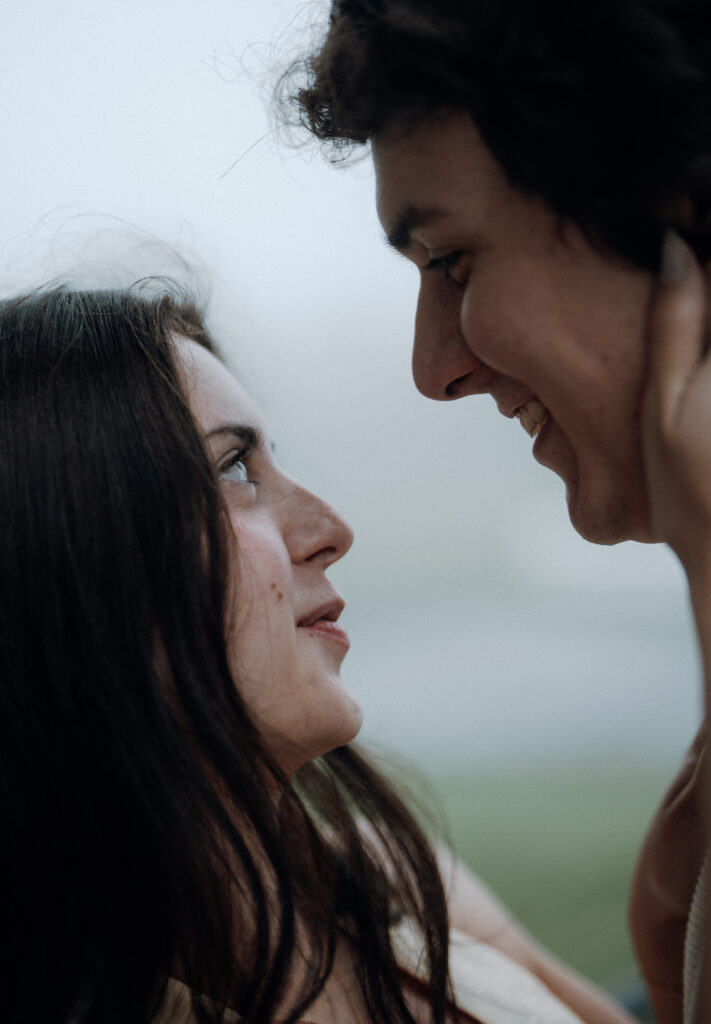 Moody North Carolina engagement photos captured at the couple’s proposal spot in the Smoky Mountains, surrounded by fog and soft overcast light. Romantic and cinematic portraits by destination wedding and engagement photographer KNCAPTURES. Moses Cone