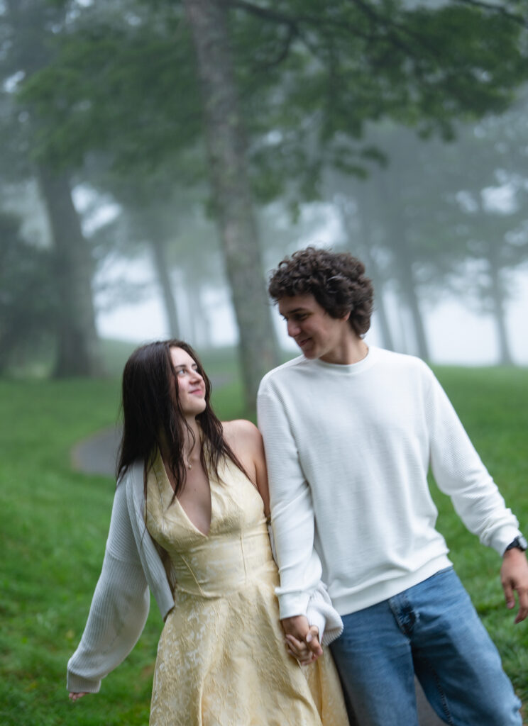 Moody North Carolina engagement photos captured at the couple’s proposal spot in the Smoky Mountains, surrounded by fog and soft overcast light. Romantic and cinematic portraits by destination wedding and engagement photographer KNCAPTURES. Moses Cone
