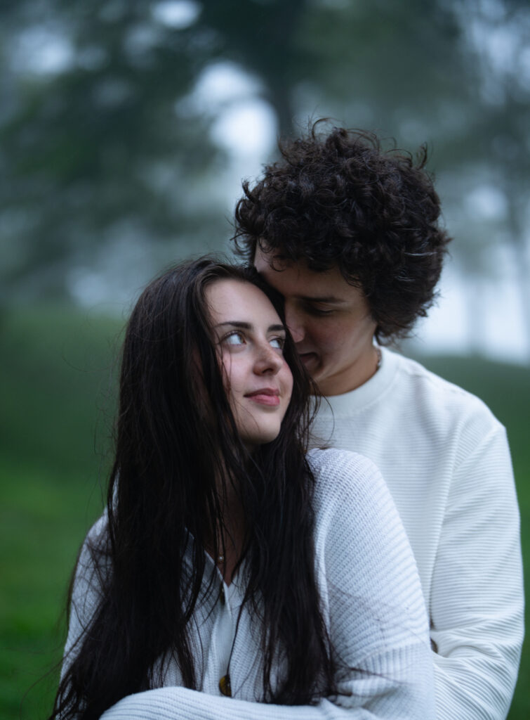 Moody North Carolina engagement photos captured at the couple’s proposal spot in the Smoky Mountains, surrounded by fog and soft overcast light. Romantic and cinematic portraits by destination wedding and engagement photographer KNCAPTURES. Moses Cone