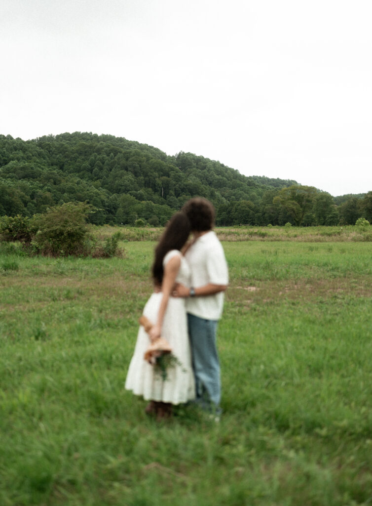 Engagement session in a misty mountain park in North Carolina, captured after the rain with soft, diffused light and natural tones. Emotional, candid moments by destination wedding photographer KNCAPTURES