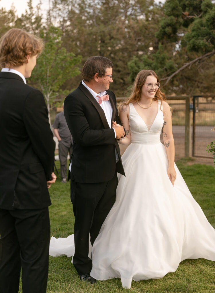 groom crying as bride walks down the aisle bend oregon wedding 