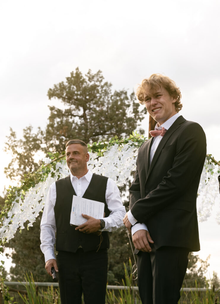 groom crying as bride walks down the aisle bend oregon wedding 