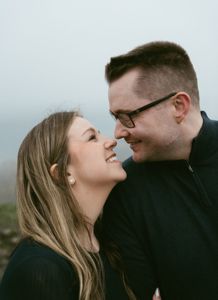 Couple embracing at Crown Point Vista House overlooking the Columbia River Gorge in Oregon