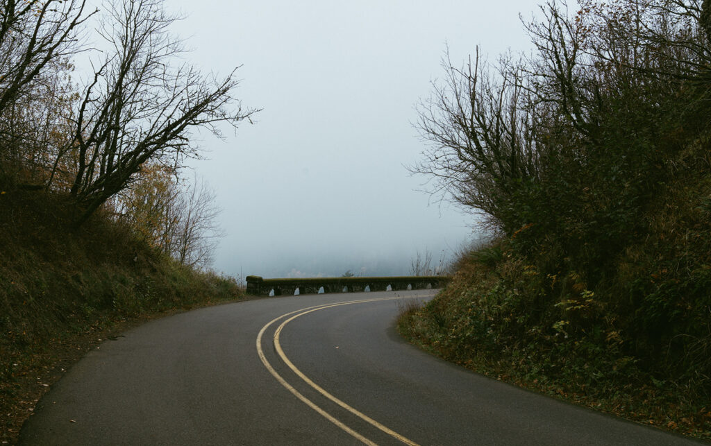 Couple embracing at Crown Point Vista House overlooking the Columbia River Gorge in Oregon