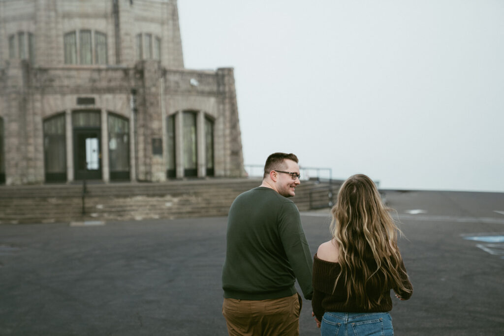 Couple embracing at Crown Point Vista House overlooking the Columbia River Gorge in Oregon