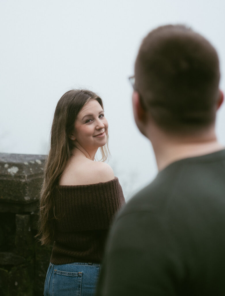 Couple embracing at Crown Point Vista House overlooking the Columbia River Gorge in Oregon