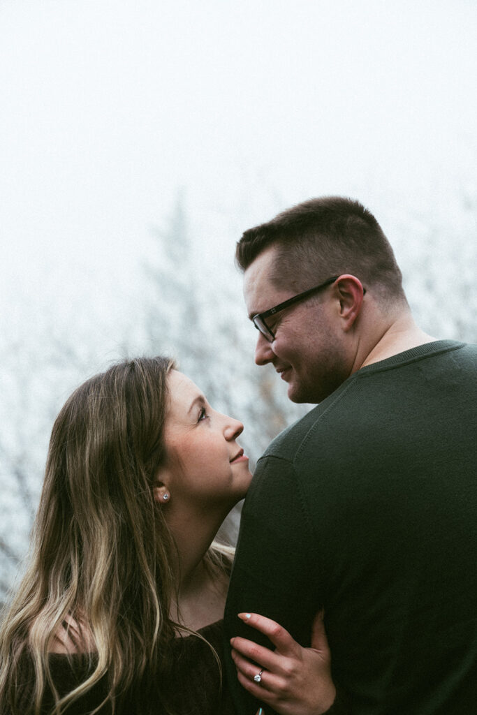 Couple embracing at Crown Point Vista House overlooking the Columbia River Gorge in Oregon