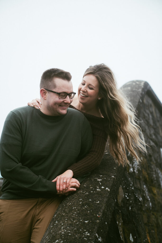 Couple embracing at Crown Point Vista House overlooking the Columbia River Gorge in Oregon