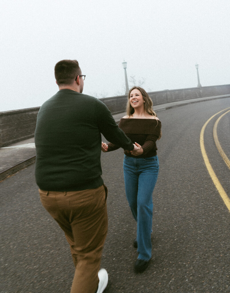 Couple embracing at Crown Point Vista House overlooking the Columbia River Gorge in Oregon