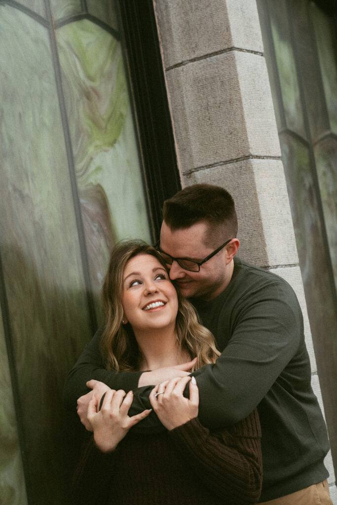 Couple embracing at Crown Point Vista House overlooking the Columbia River Gorge in Oregon