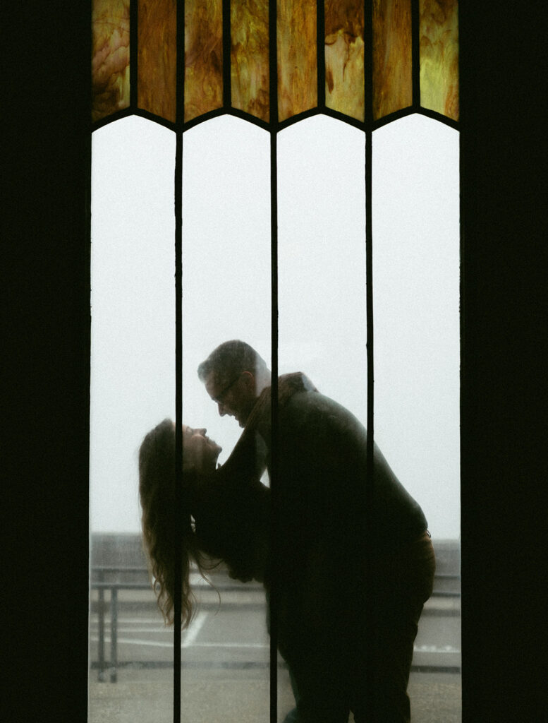 Couple embracing at Crown Point Vista House overlooking the Columbia River Gorge in Oregon