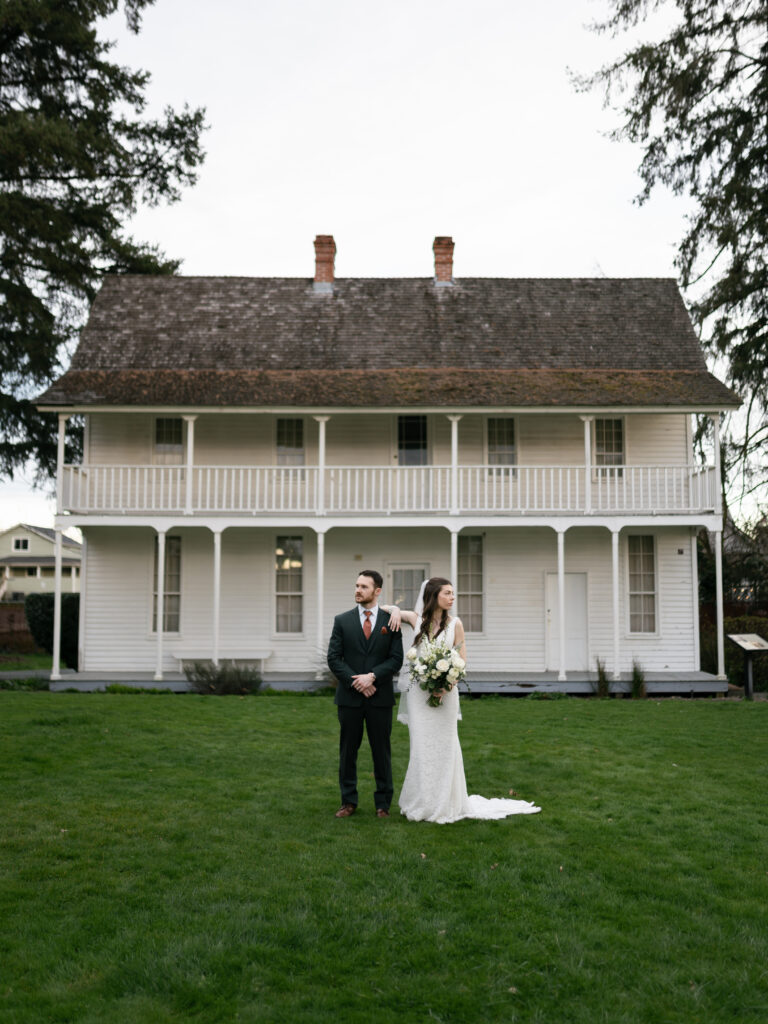 Bride and groom walking together outside the Willamette Heritage Center in Salem, Oregon during their wedding day